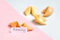 fortune cookie on pink and blue background, pastel colors, family prediction