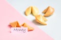 fortune cookie on pink and blue background, pastel colors, money prediction