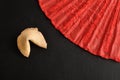 Fortune cookie and a red hand fan Royalty Free Stock Photo