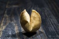 Fortune Cookie on wooden boards with a piece of hope paper inside