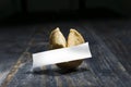 Fortune Cookie on wooden table with a blank sheet of hope paper Royalty Free Stock Photo