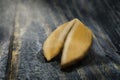 Fortune Cookie on wooden table with a piece of hope paper inside