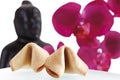 Fortune cookies, buddha head and orchid leaves in background Royalty Free Stock Photo