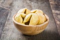 Fortune cookies in wooden bowl on wood