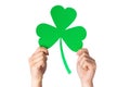 Hands holding green paper shamrock Royalty Free Stock Photo