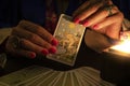 Fortune teller hands showing The Star tarot card, symbol of hope. Close-up, moody atmosphere