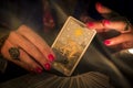 Fortune teller hands showing The Star tarot card, symbol of hope. Close-up, moody atmosphere