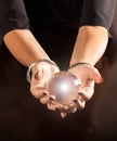 Fortune teller holding a crystal ball in her hands Royalty Free Stock Photo