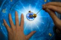 Fortune teller with magic pendulum on blue horoscope like astrology, zodiac. esoteric topic