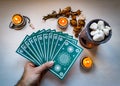 Fortune teller man with blue tarot cards on white wooden table b