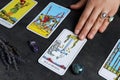 Fortune teller predicting future on spread of tarot cards at grey table, closeup Royalty Free Stock Photo