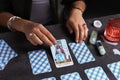 Fortune teller predicting future on spread of tarot cards at grey table, closeup Royalty Free Stock Photo