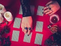 A fortune teller predicts the future using the cards on the red table. blank for the designer.