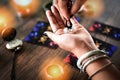 Fortune teller reading fortune lines on hand Palmistry Psychic readings and clairvoyance hands with Tarot cards divination Royalty Free Stock Photo