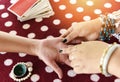 Fortune teller reading fortune lines on hand Palmistry Psychic readings and clairvoyance hands with Tarot cards divination Royalty Free Stock Photo