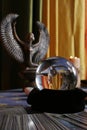 Fortune teller`s table with crystal ball, incense, candles and other occult objects Royalty Free Stock Photo