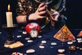 A fortune teller shuffles tarot cards, surrounded by magical and mysterious objects. Hands close-up. The concept of astrology, Royalty Free Stock Photo