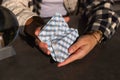 Fortune teller shuffling deck of tarot cards at grey table, closeup Royalty Free Stock Photo