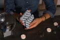 Fortune teller shuffling deck of tarot cards at grey table, closeup Royalty Free Stock Photo