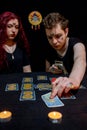 Fortune teller using tarot cards on black background Royalty Free Stock Photo