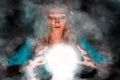 Fortune teller woman with light sphere in her hands