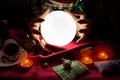 Fortune teller woman looking at crystal ball with her hands around crystal ball Royalty Free Stock Photo