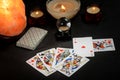 Fortune-telling cards of different stripes, candles, crystal nasty ball on