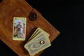 Fortune-telling on cards.Tarot cards on an old book, an arcana - lovers and an engagement ring