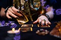 Fortune-telling on cards. A fortune teller lays out Tarot cards. Close up of hands. Zodiac circles are located in the Royalty Free Stock Photo