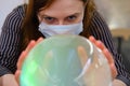 Fortune telling on the crystal ball about the future of coronavirus, copy space. Magician influenza virus in a fortune teller`s