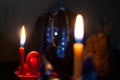 Fortune telling, ritual, magic, clairvoyance, witchcraft in the night. Soft focus, one candle out of focus. Burning candles in the Royalty Free Stock Photo