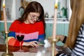 Fortune telling on tarot cards. An attractive young woman and a sorceress discover their future Royalty Free Stock Photo