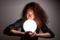 Fortuneteller holding her hands a glowing ball Royalty Free Stock Photo