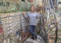 Forty-five yearold caucasian mother posing in the Magic Garden by Isaiah Zagar, Philadelphia