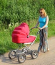 Forty-year mother walks with a baby carriage