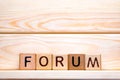 Forum word concept. The word Forum on wooden cubes. Forum as steps to progress our business. Forum to control our health Royalty Free Stock Photo