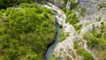 Forward aerial video of Moravica river, following it's canyon, during spring season full of green vegetation