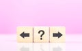 Forward and backward arrows on wooden blocks, symbolizing the concept of thought development. Reflects the process of reflecting