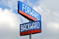 Forward and backward - street sign, sky in background Royalty Free Stock Photo