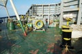 Forward mooring station behind windbreaker with winch and anchor windlass with chain and heaved up white manila rope. Royalty Free Stock Photo