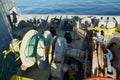 Forward port side mooring winch and anchor windlass with chain and heaved up green manila rope. Royalty Free Stock Photo