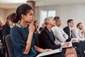 Forward-thinking. Multi-ethnic audience sitting in a row while listening to presentation at conference hall Royalty Free Stock Photo