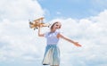 Forward to adventure. teen girl play with wooden plane. kid fashion style. concept of traveling. happy childhood. cute