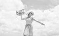 Forward to adventure. teen girl play with wooden plane. kid fashion style. concept of traveling. happy childhood. cute