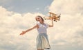 Forward to adventure. teen girl play with wooden plane. kid fashion style. concept of traveling. happy childhood. cute