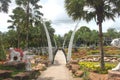 A forward view to a bridge with meadow and grass and trees and stones in the Nong Nooch tropical botanic garden near Pattaya city