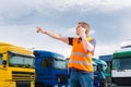 Forwarder in front of trucks on a depot Royalty Free Stock Photo