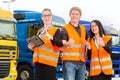 Forwarder in front of trucks on a depot Royalty Free Stock Photo