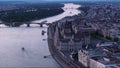 Forwards fly above wide river Danube in city. Beautiful popular building of Hungarian Parliament. Orszaghaz on