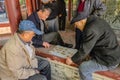 Senior Chinese People let relax and playing Chinese Chess in The Ancestral temple park.Foshan city china